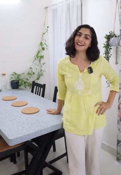 Eco-friendly recycled dining table with metal base and colorful surface, seats 4 people